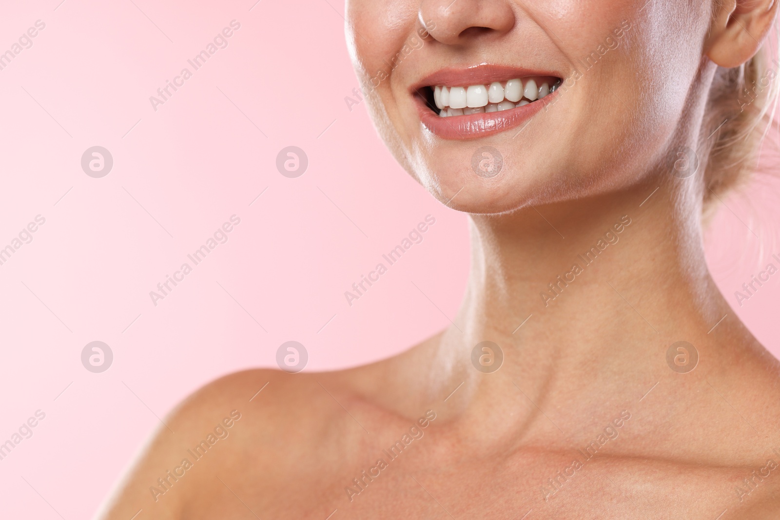 Photo of Woman with beautiful healthy teeth on pink background, closeup. Space for text