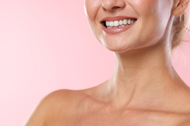 Photo of Woman with beautiful healthy teeth on pink background, closeup. Space for text