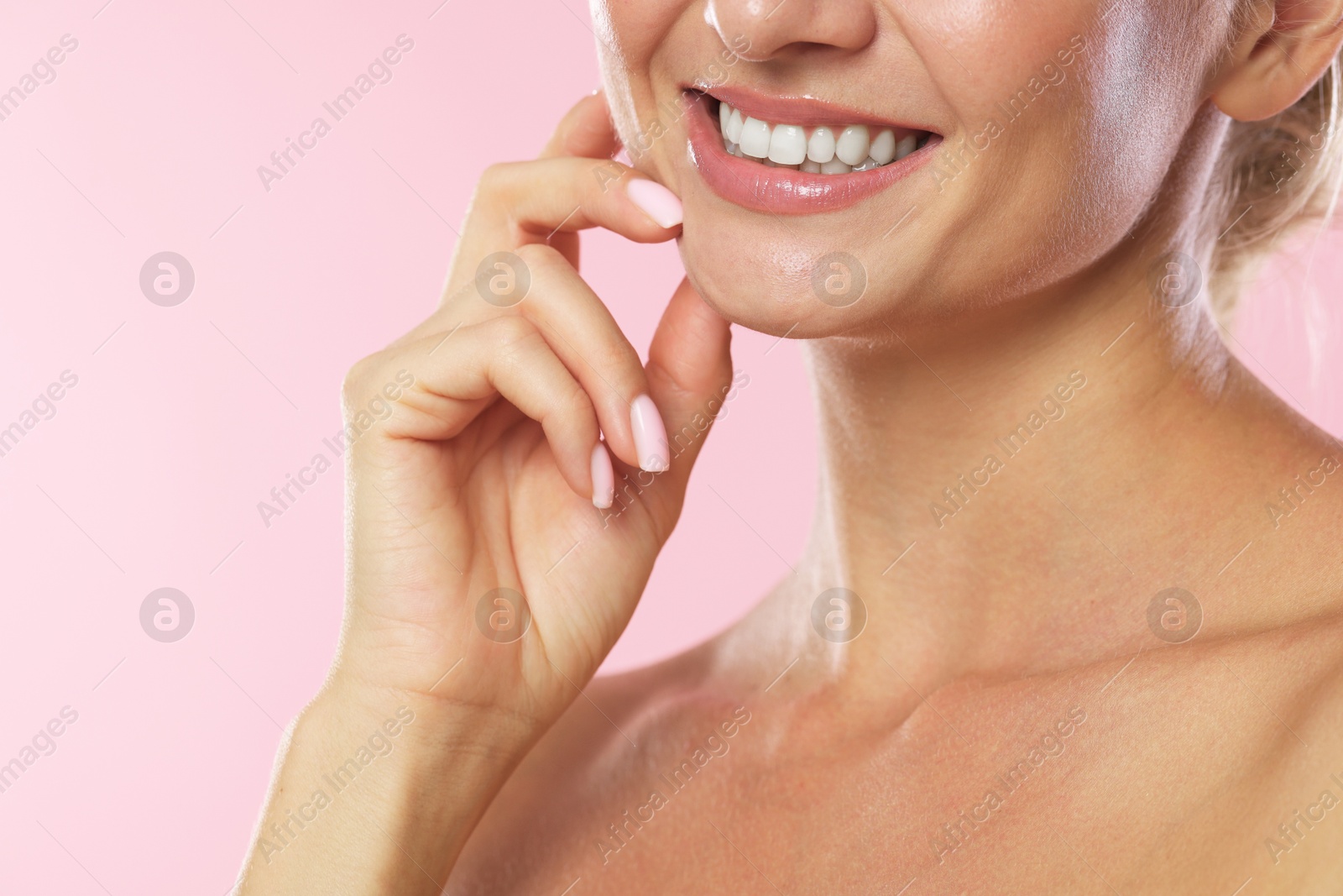 Photo of Woman with beautiful healthy teeth on pink background, closeup