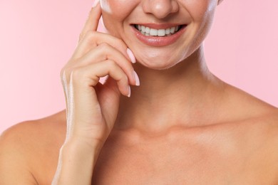 Photo of Woman with beautiful healthy teeth on pink background, closeup