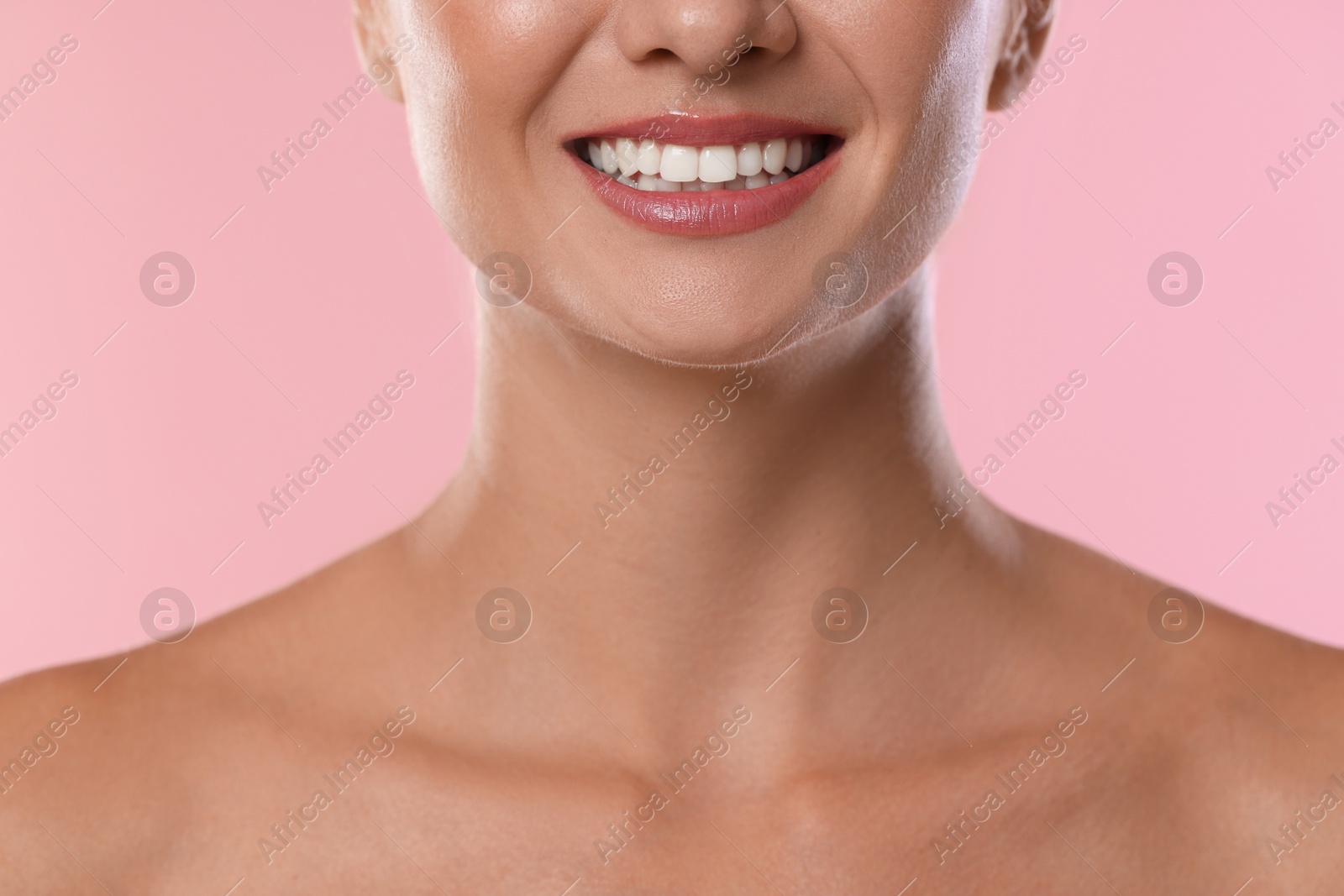 Photo of Woman with beautiful healthy teeth on pink background, closeup