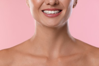 Photo of Woman with beautiful healthy teeth on pink background, closeup
