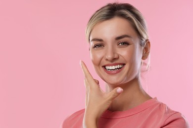 Photo of Woman with beautiful healthy teeth on pink background. Space for text
