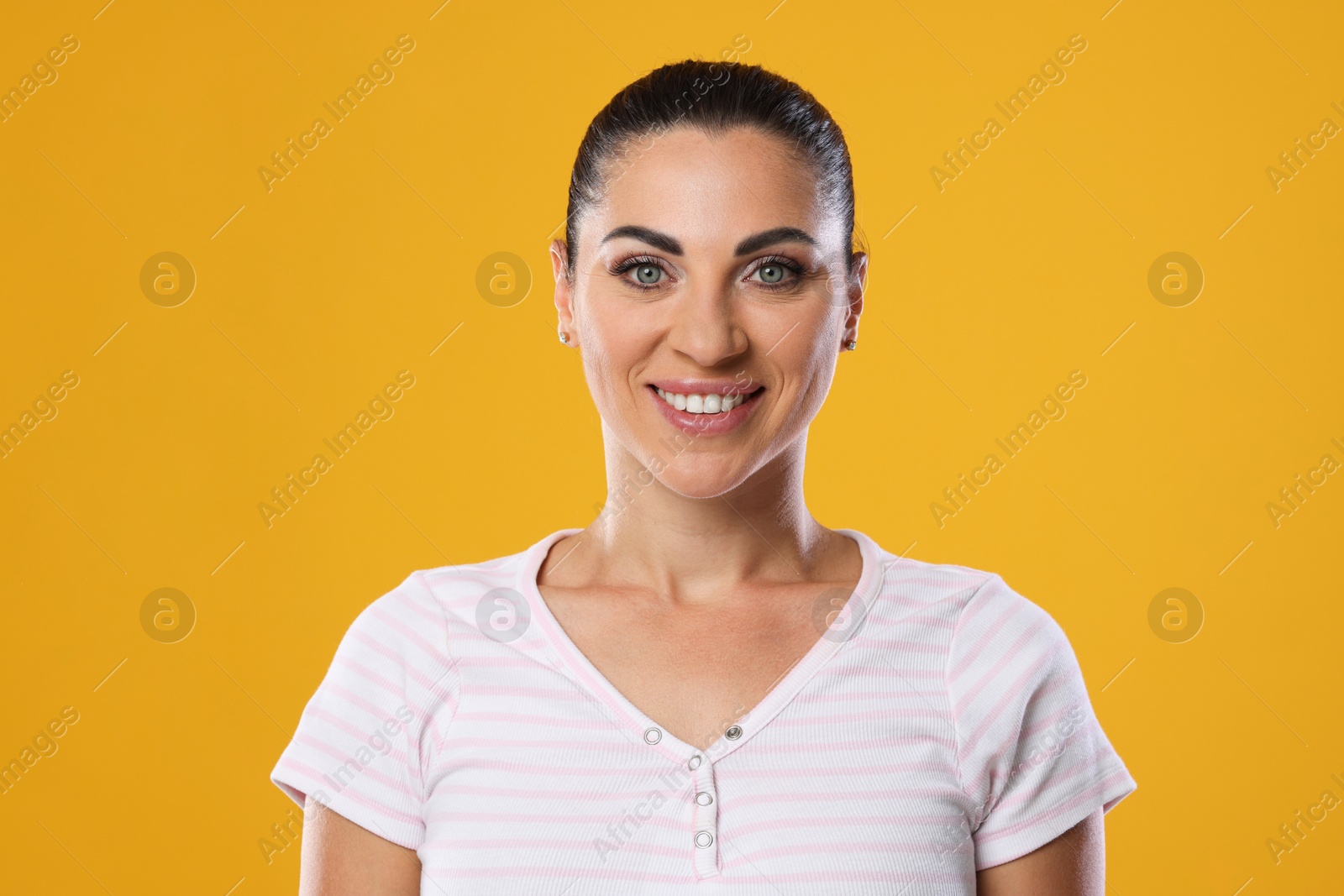 Photo of Woman with beautiful healthy teeth on yellow background