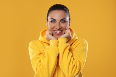 Photo of Woman with beautiful healthy teeth on yellow background
