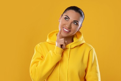 Photo of Woman with beautiful healthy teeth on yellow background