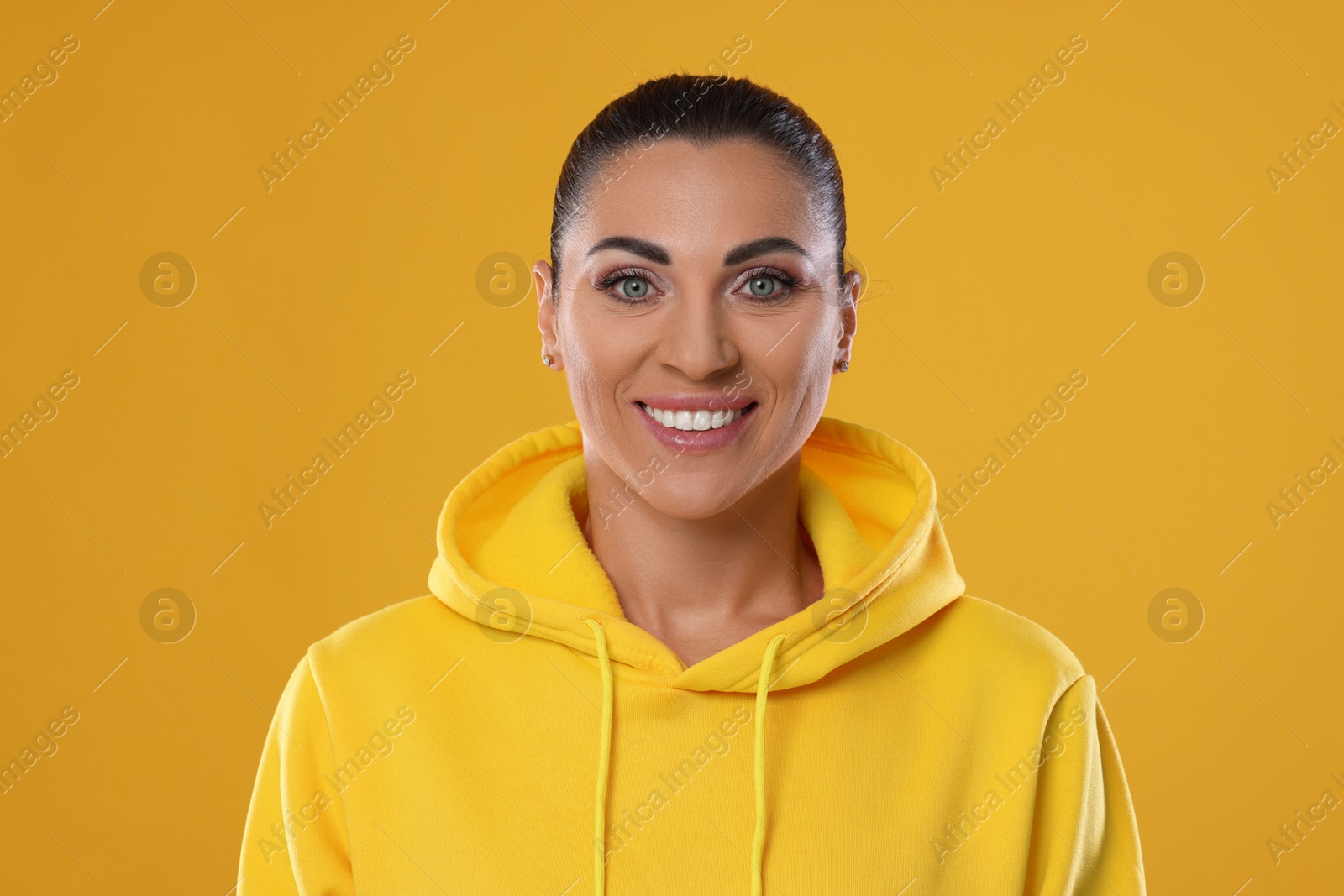 Photo of Woman with beautiful healthy teeth on yellow background