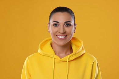 Photo of Woman with beautiful healthy teeth on yellow background