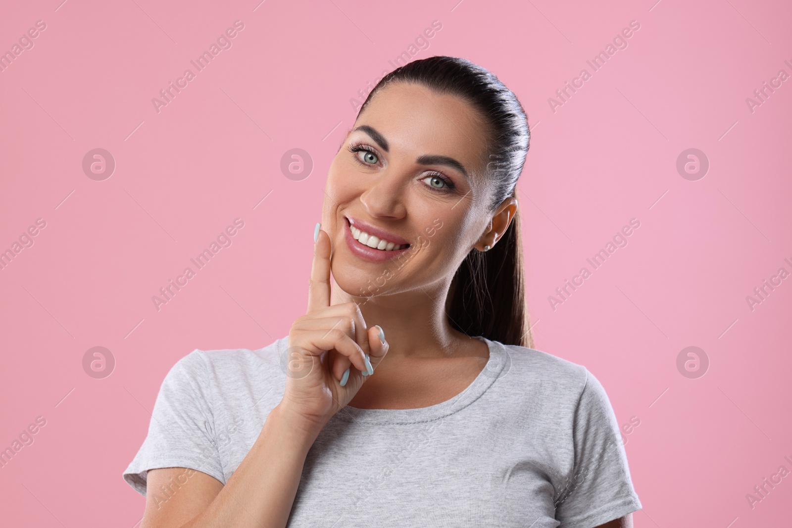 Photo of Woman with beautiful healthy teeth on pink background