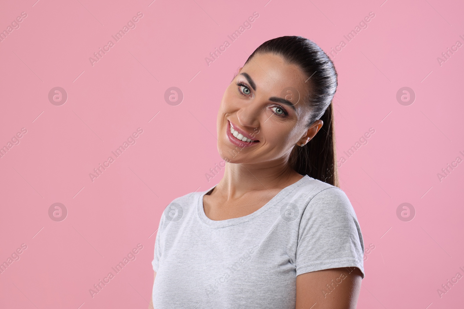 Photo of Woman with beautiful healthy teeth on pink background. Space for text