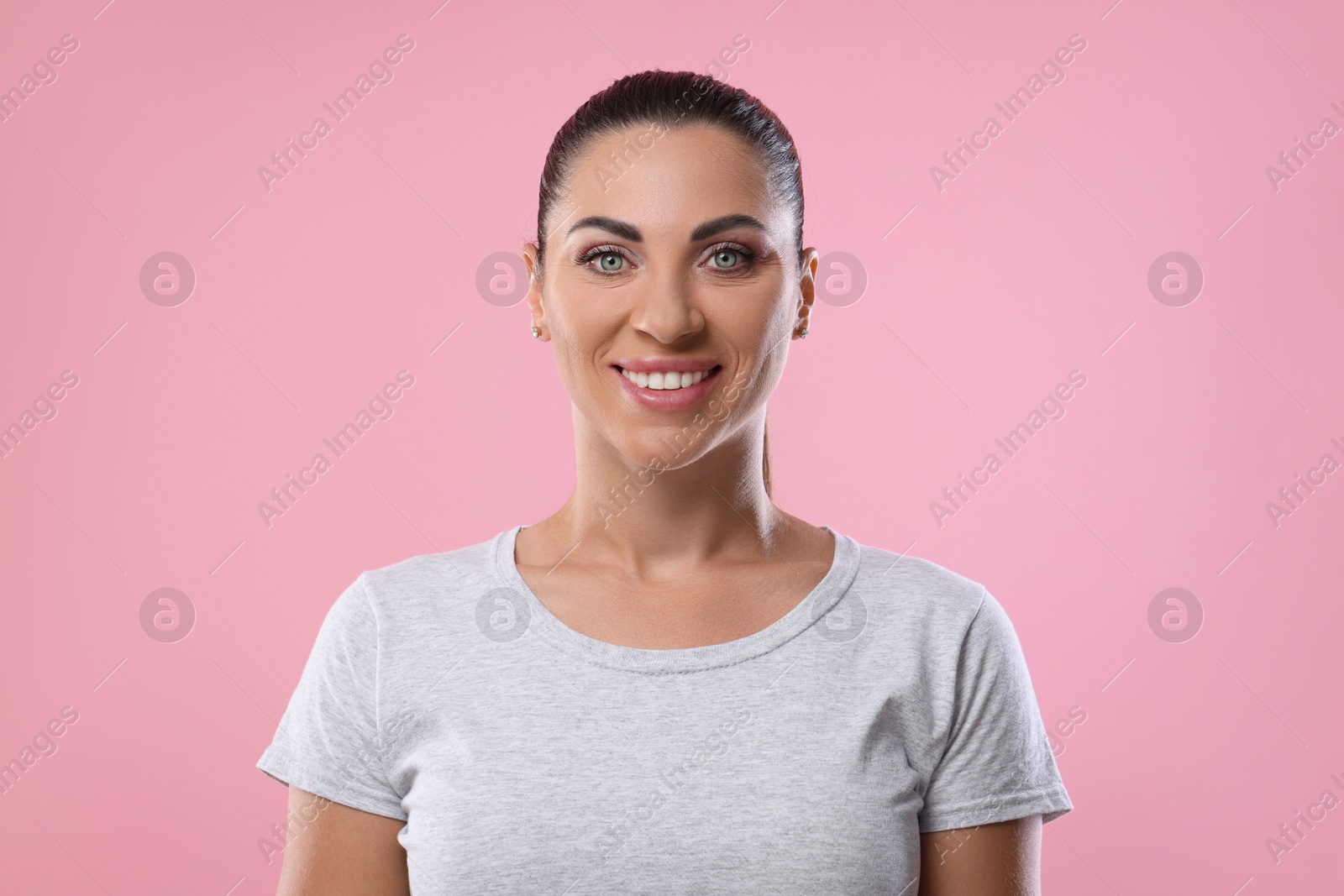 Photo of Woman with beautiful healthy teeth on pink background