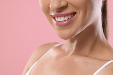 Photo of Woman with beautiful healthy teeth on pink background, closeup. Space for text
