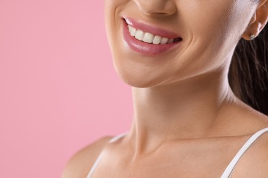 Photo of Woman with beautiful healthy teeth on pink background, closeup. Space for text