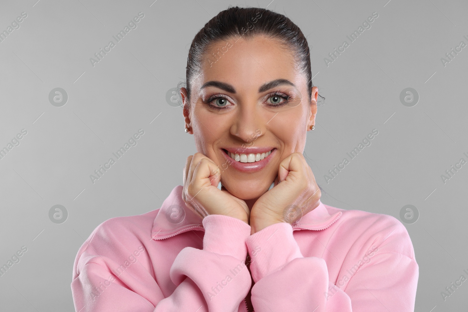 Photo of Woman with beautiful healthy teeth on light grey background