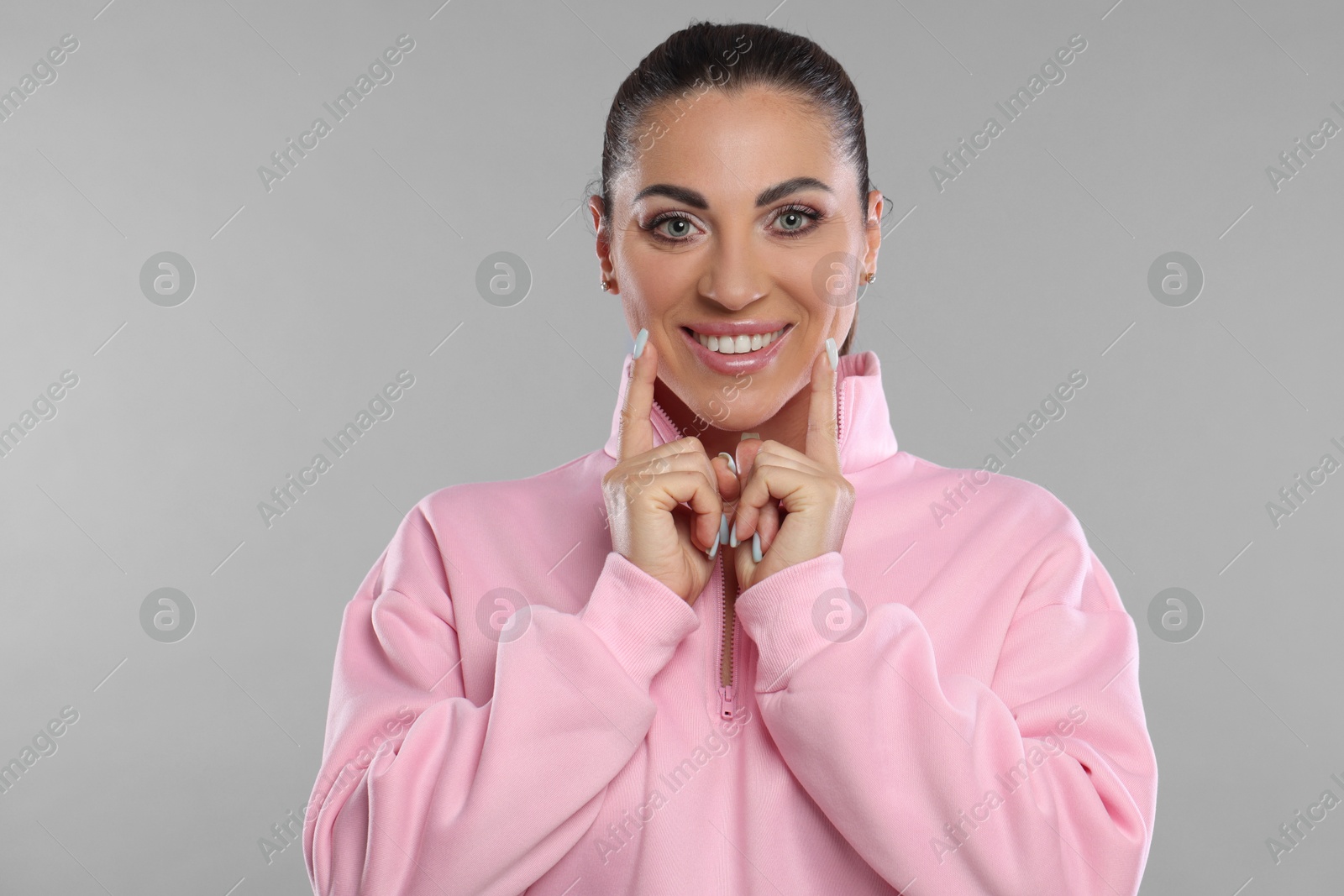 Photo of Woman with beautiful healthy teeth on light grey background. Space for text