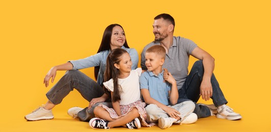 Photo of Lovely family posing together on yellow background