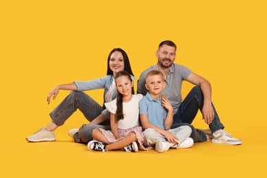 Photo of Lovely family posing together on yellow background