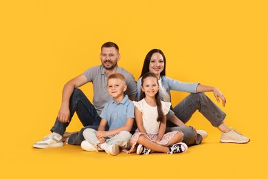 Photo of Lovely family posing together on yellow background