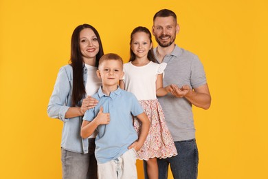 Photo of Portrait of happy family on yellow background