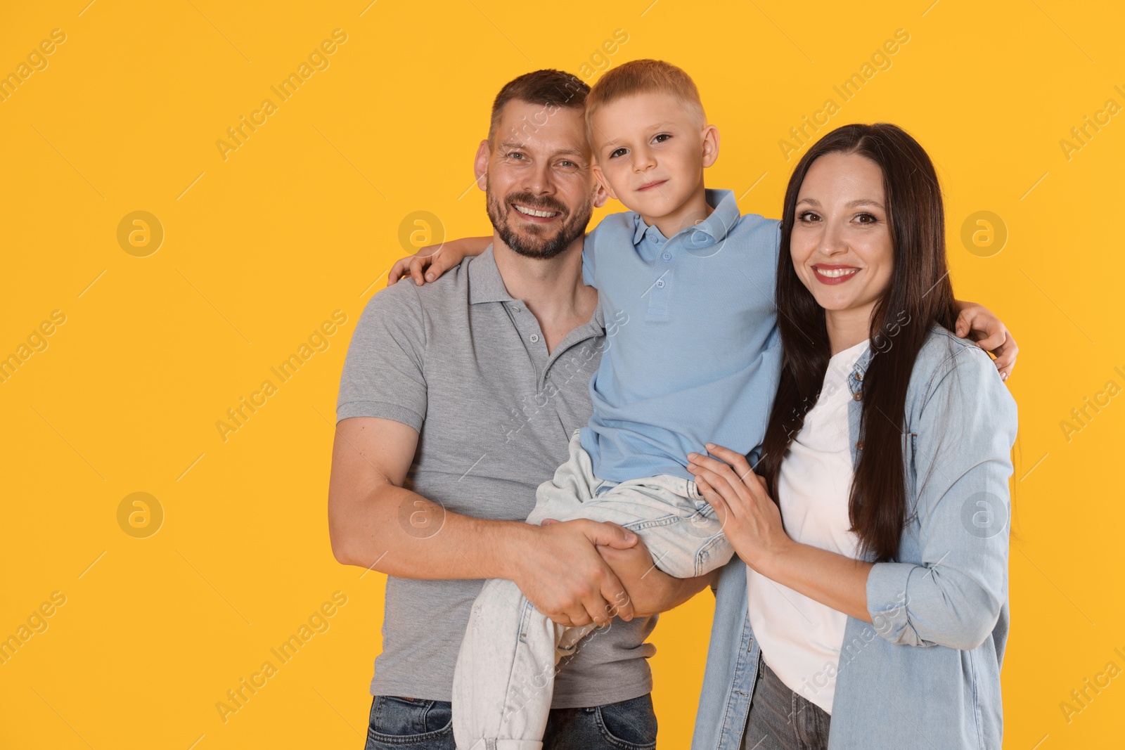 Photo of Portrait of happy family on yellow background. Space for text