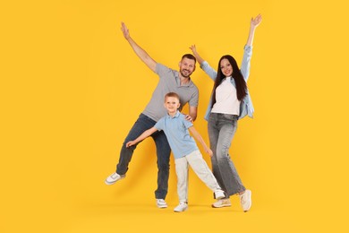 Photo of Happy family having fun on yellow background