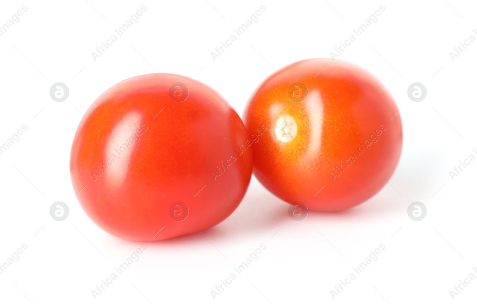 Two ripe cherry tomatoes isolated on white Photo of Two ripe cherry tomatoes isolated on white