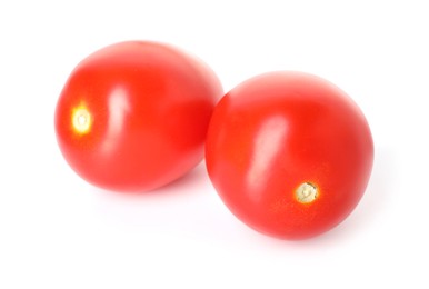 Photo of Two ripe red tomatoes isolated on white