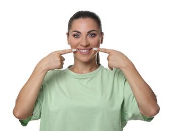 Photo of Woman pointing at her healthy teeth on white background
