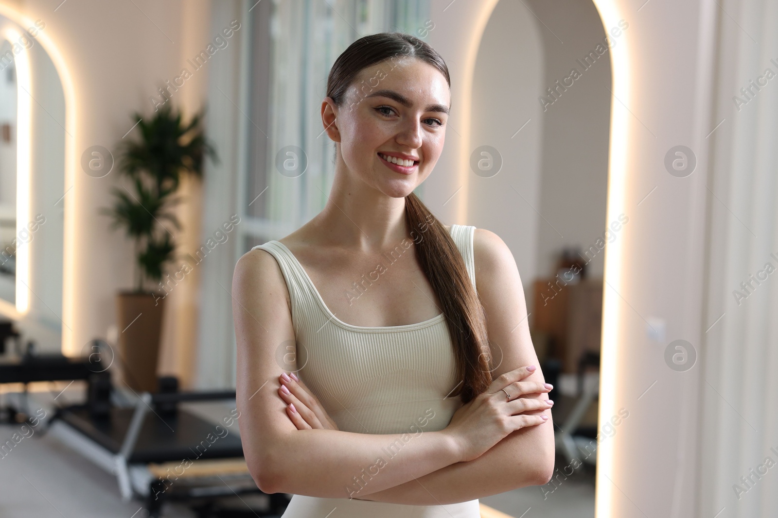 Happy woman wearing sportswear in pilates studio Photo of Happy woman wearing sportswear in pilates studio