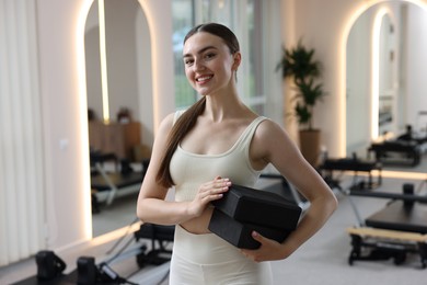 Photo of Woman with foam blocks in pilates studio