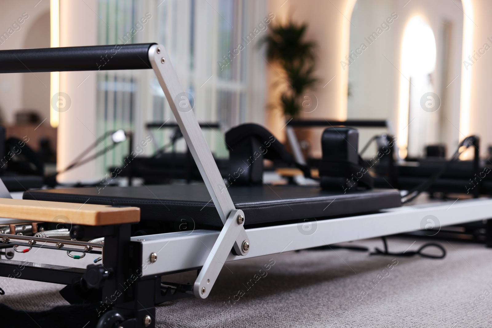 Reformer machines in studio, closeup. Pilates equipment Photo of Reformer machines in studio, closeup. Pilates equipment