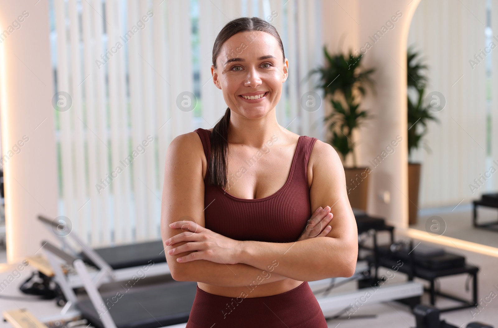 Happy woman wearing sportswear in pilates studio Photo of Happy woman wearing sportswear in pilates studio
