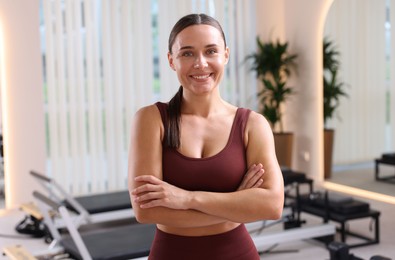 Photo of Happy woman wearing sportswear in pilates studio