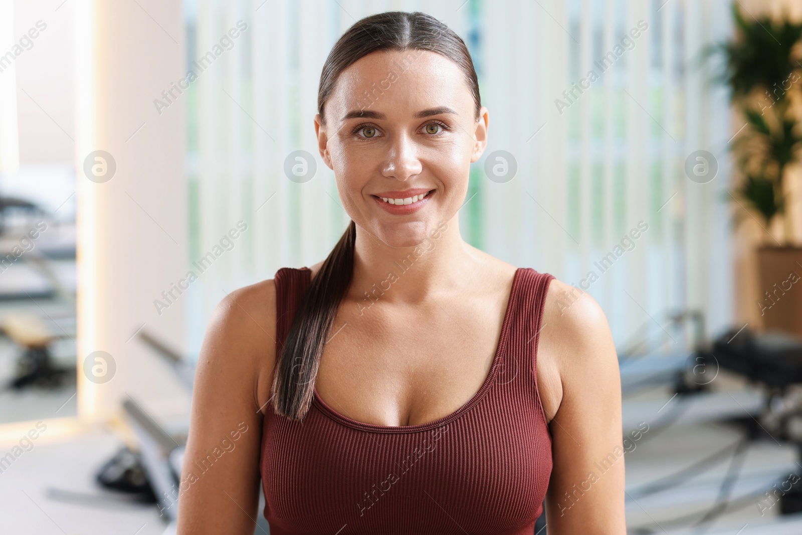 Happy woman wearing sportswear in pilates studio Photo of Happy woman wearing sportswear in pilates studio