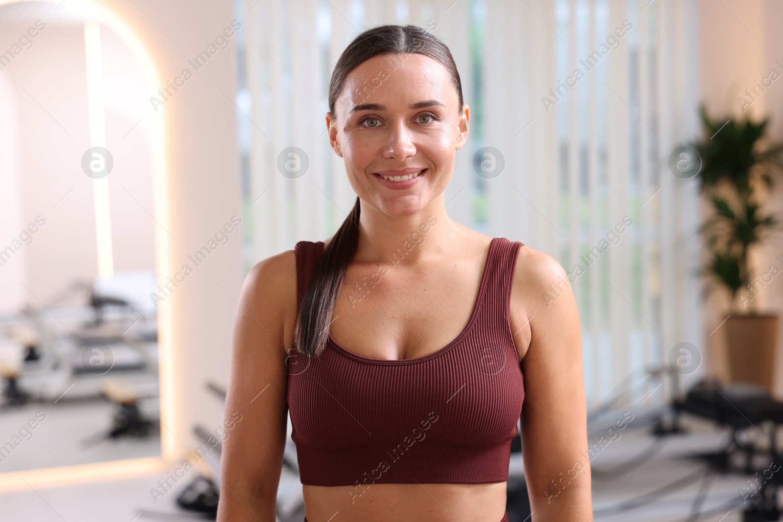 Happy woman wearing sportswear in pilates studio Photo of Happy woman wearing sportswear in pilates studio