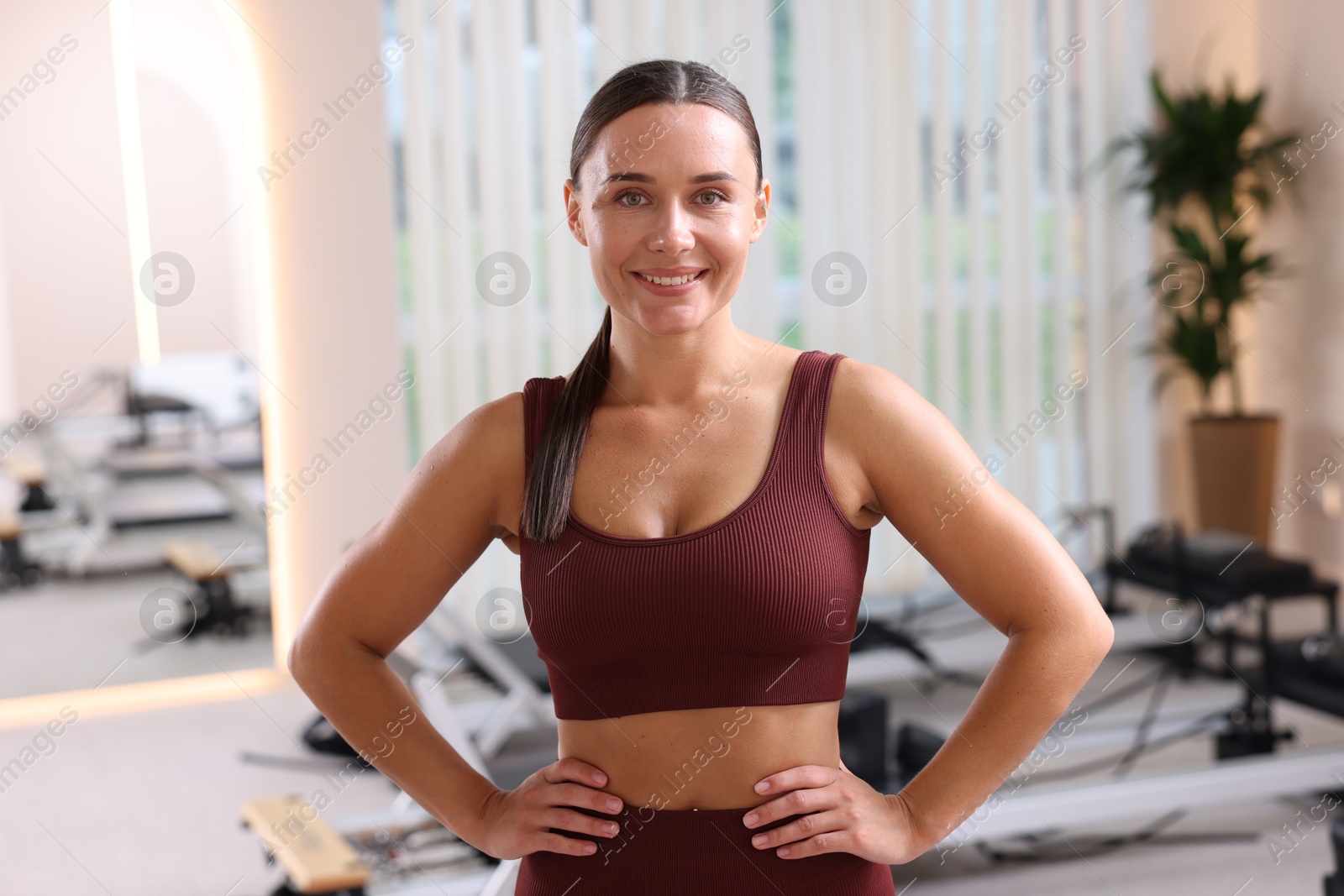 Happy woman wearing sportswear in pilates studio Photo of Happy woman wearing sportswear in pilates studio