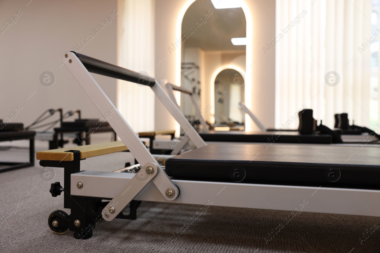 Reformer machines in studio, closeup. Pilates equipment Photo of Reformer machines in studio, closeup. Pilates equipment