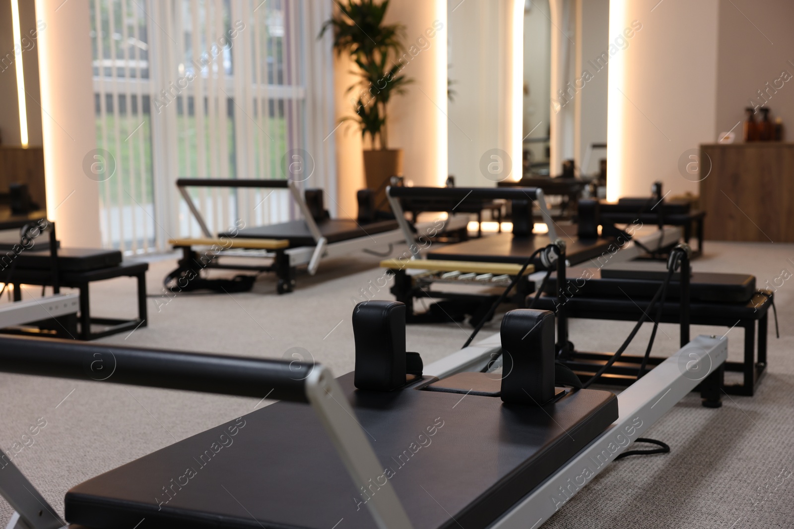 Reformer machines in studio, closeup. Pilates equipment Photo of Reformer machines in studio, closeup. Pilates equipment