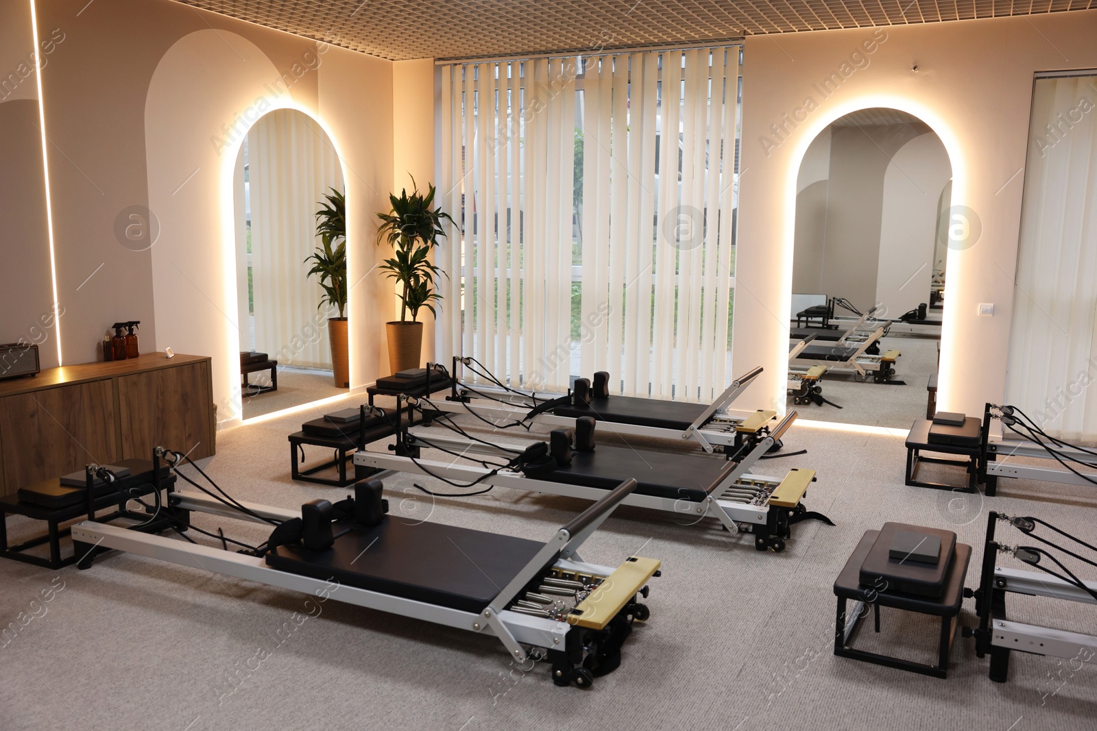 Many reformer machines in studio. Pilates equipment Photo of Many reformer machines in studio. Pilates equipment