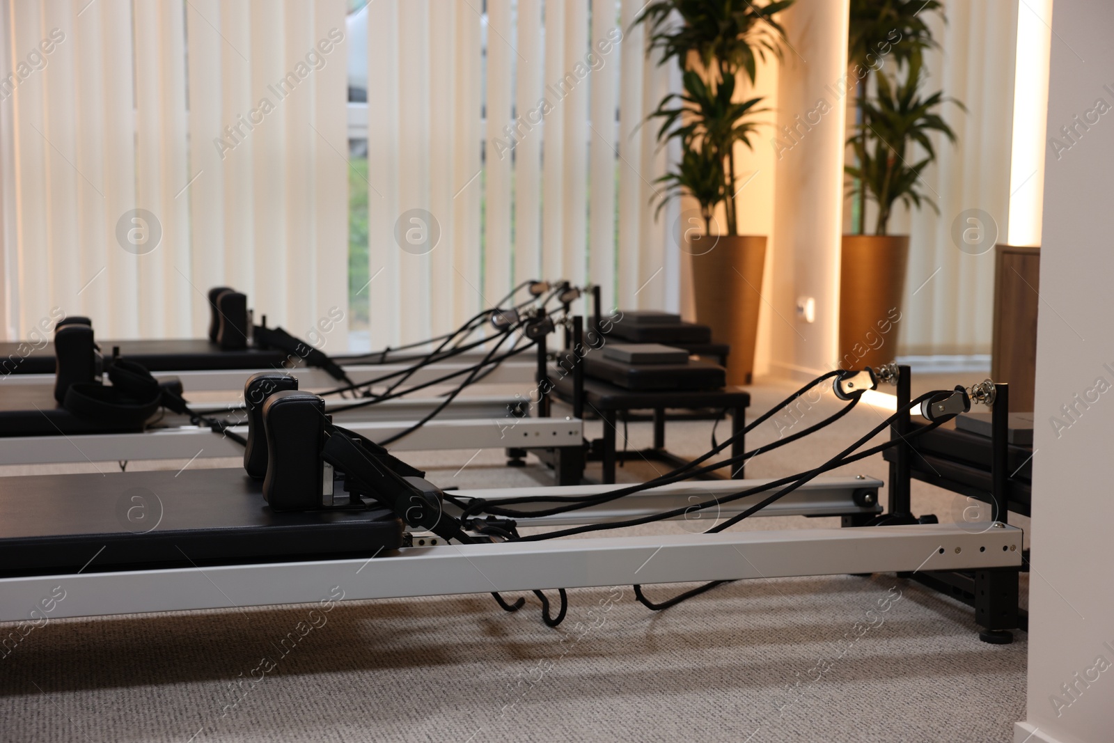 Reformer machines in studio, closeup. Pilates equipment Photo of Reformer machines in studio, closeup. Pilates equipment