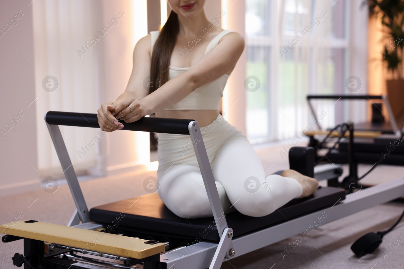 Photo of Woman on reformer in pilates studio, closeup