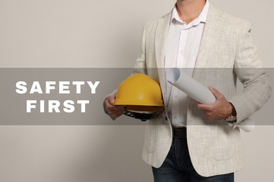 Image of Safety first, poster. Engineer with hard hat and draft on white background, closeup