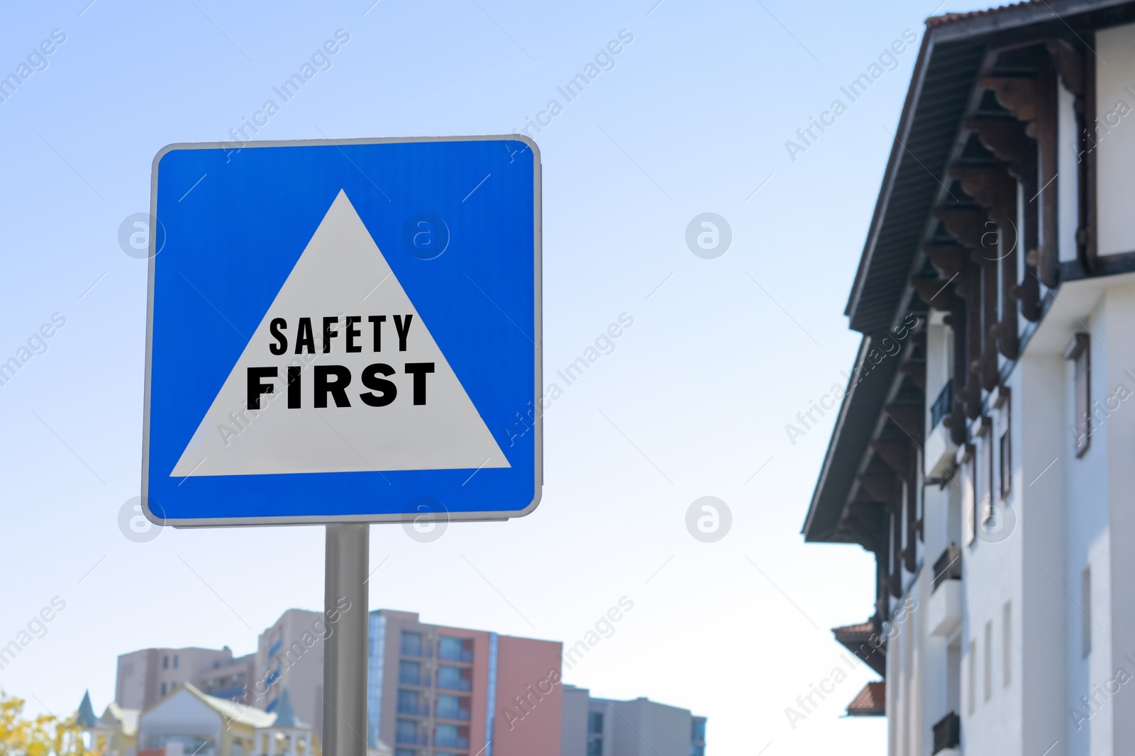 Image of Safety First sign on pole near building outdoors