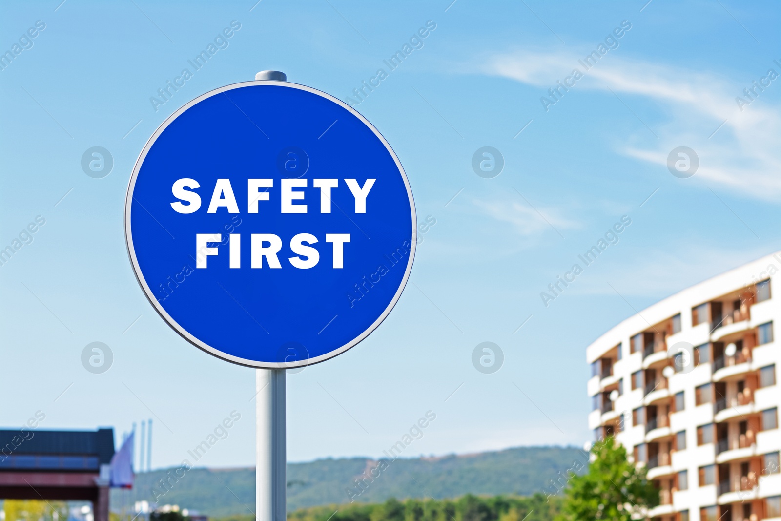 Image of Safety First sign on pole in city outdoors