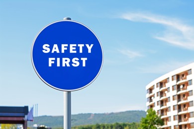 Image of Safety First sign on pole in city outdoors