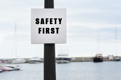 Image of Safety First sign on pole near bay outdoors