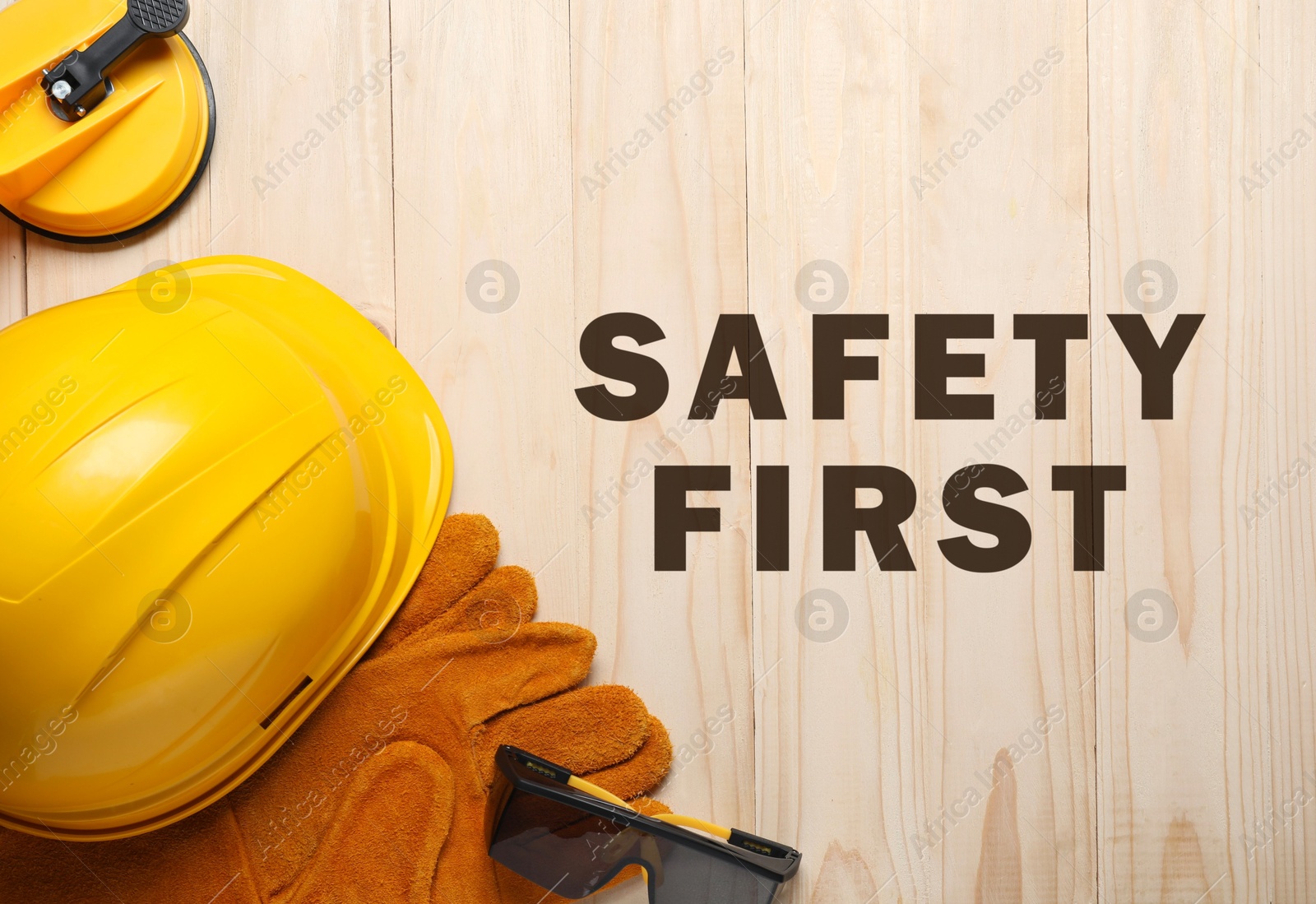 Safety first, poster. Personal protective equipment on wooden background, top view Image of Safety first, poster. Personal protective equipment on wooden background, top view