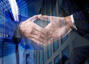 Image of Business partners shaking hands against office buildings, multiple exposure with flag. Deal, agreement, partnership, success