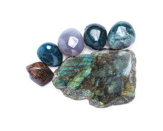 Photo of Many different healing stones isolated on white, top view