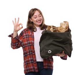 Photo of Recycling. Smiling woman with bag full of different waste paper showing OK gesture on white background